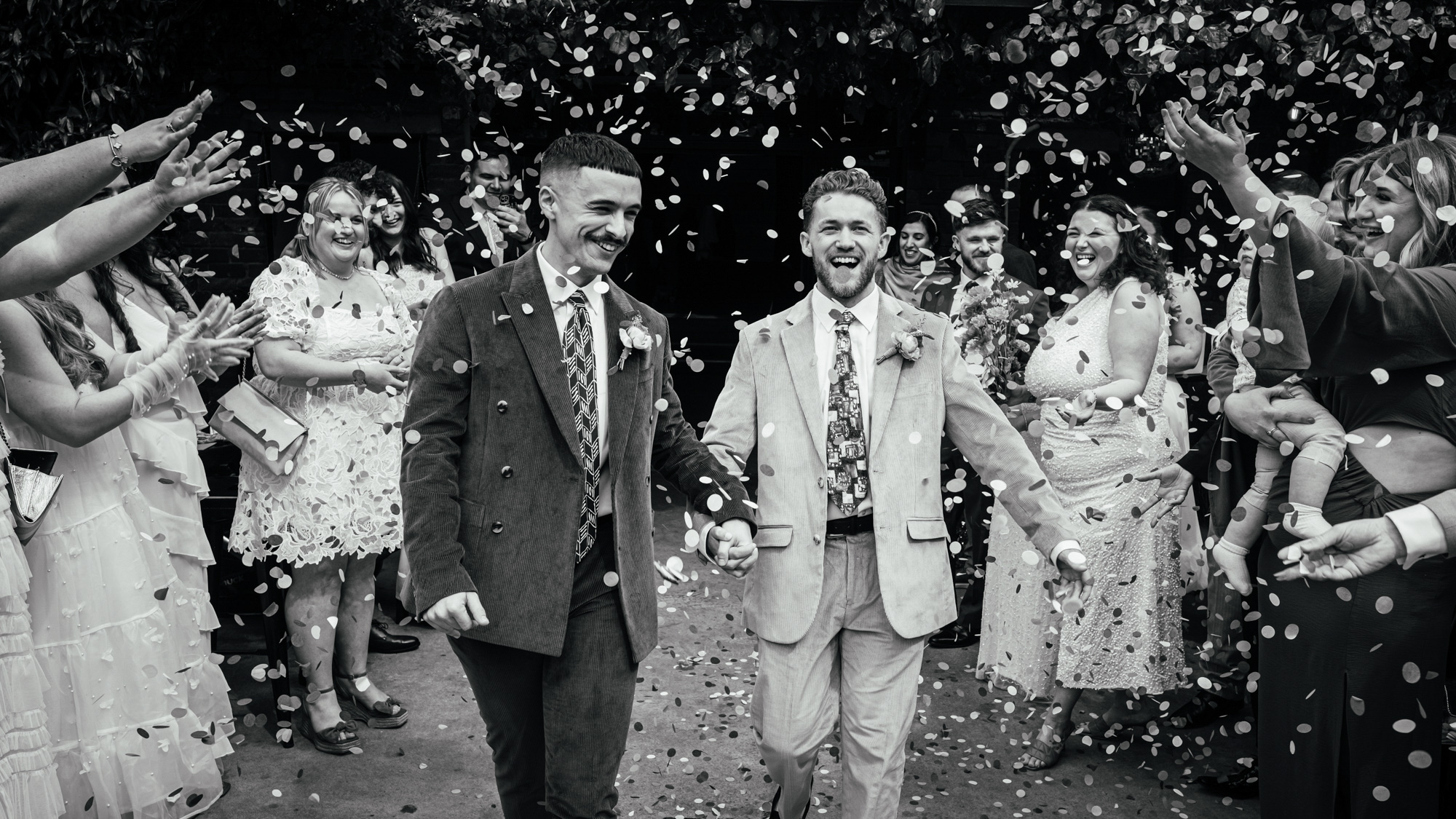 Confetti moment in black and white by UK documentary wedding photographer Simon Dewey