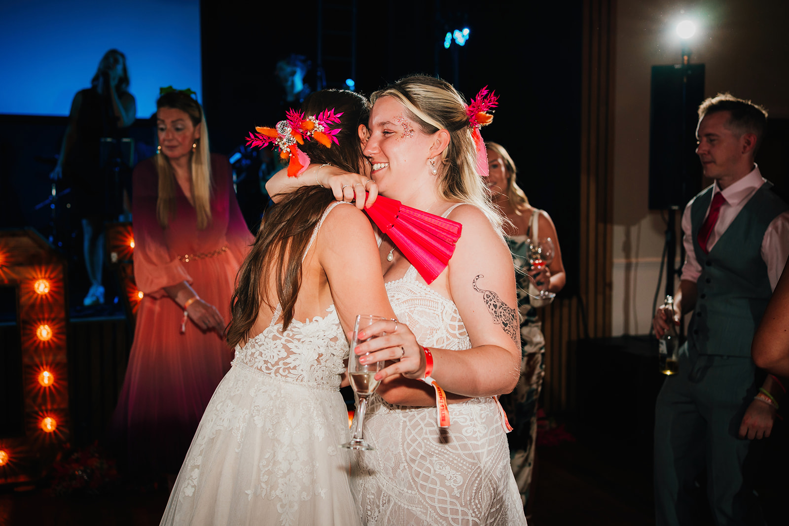 Photos from a colourful pink and orange glitter ball wedding near Westbury by Becky Weir Photography