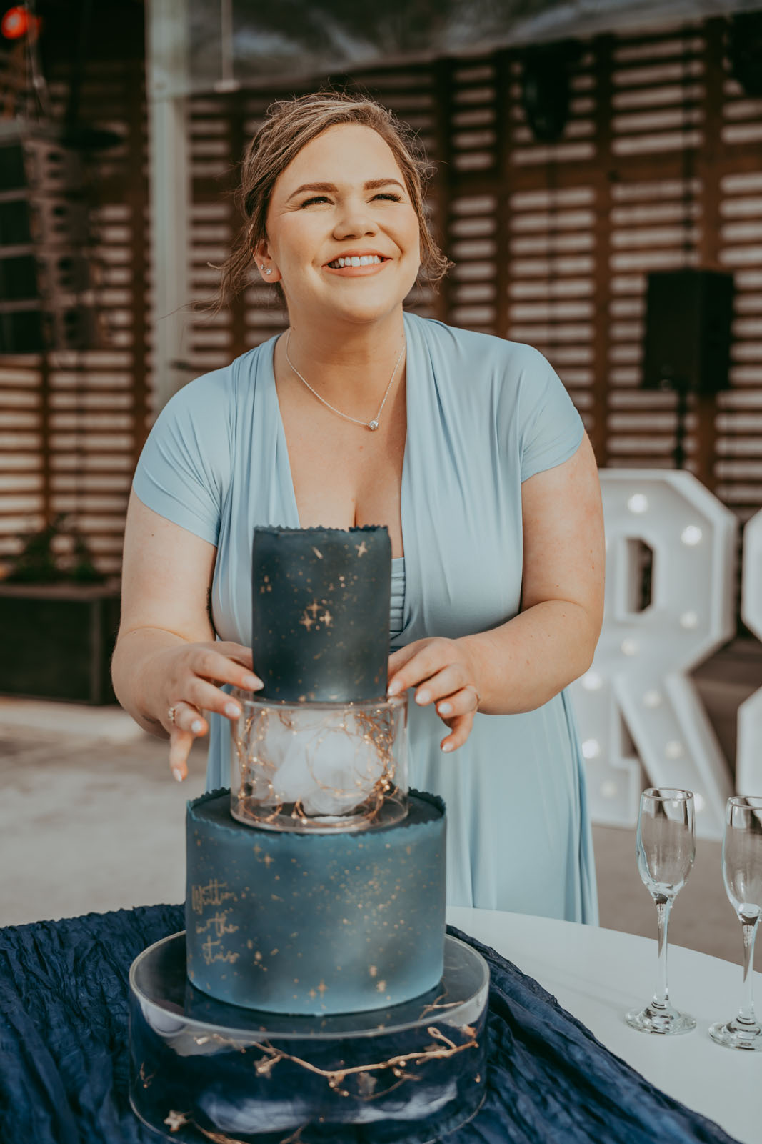 Three tier wedding cake in celestial starry dark blues with copper detail - Baked by Alexandra