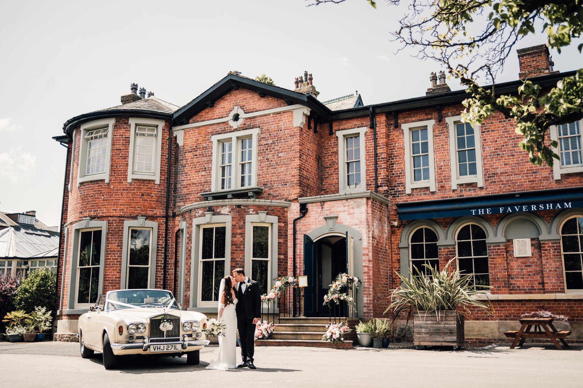 Newlyweds portrait outside the Faversham on a bright sunny day by Yorkshire documentary wedding photographer David Lindsley