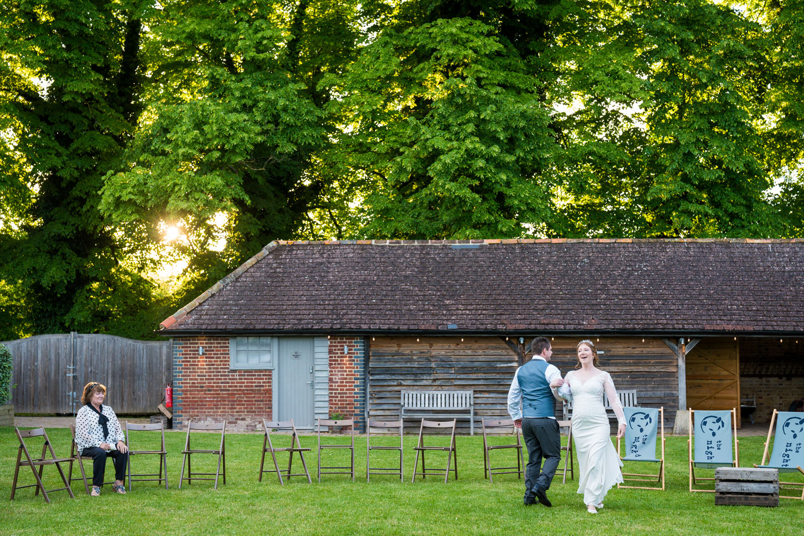 Groom and bride dance as a wedding guest watches - Benjamin Toms Photography | Kent