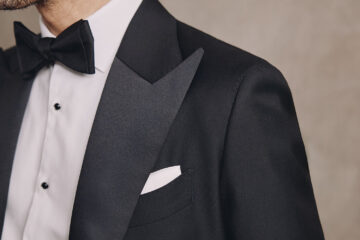 Close up of a man wearing a wedding suit with bow tie by MOSS