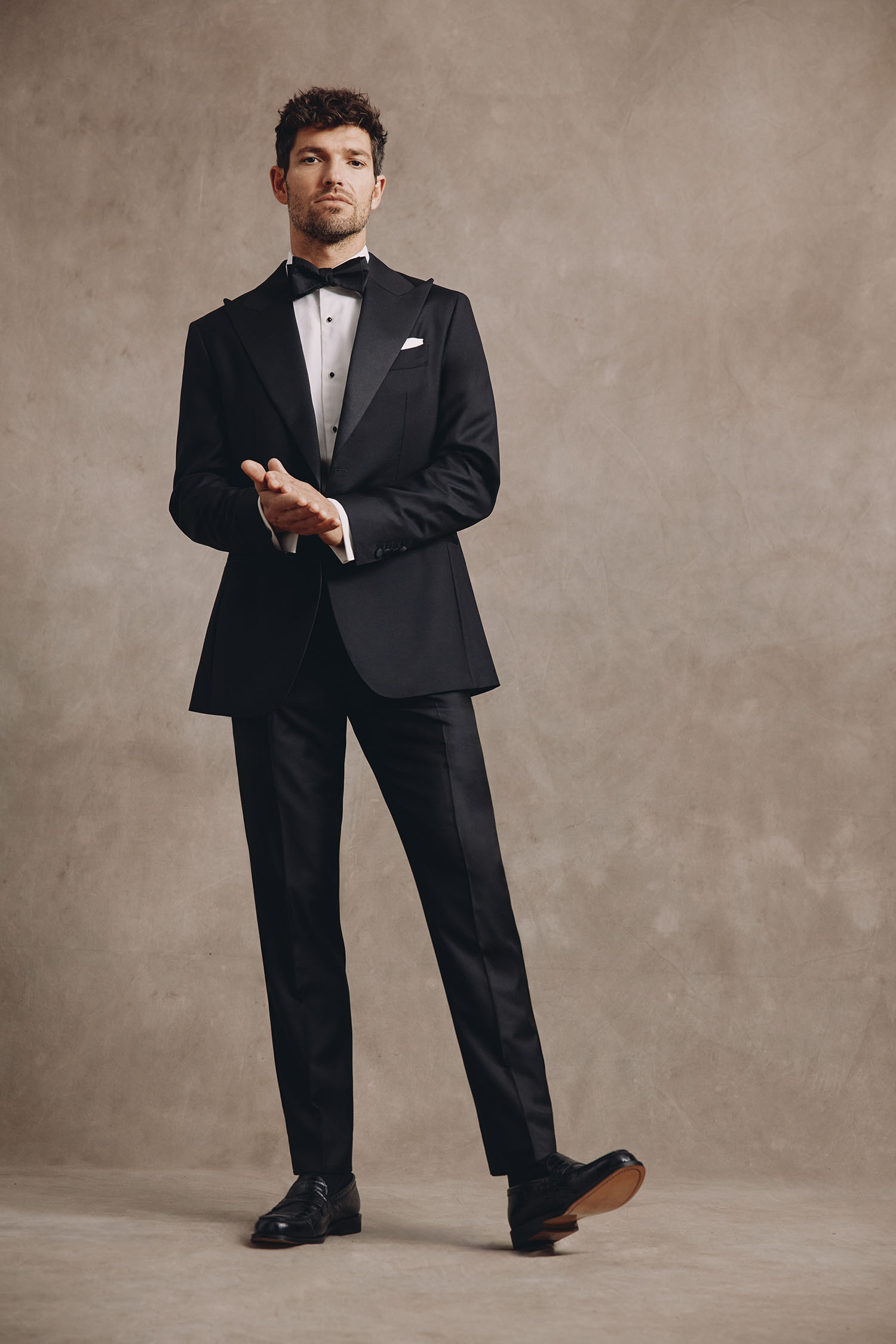 Model wearing black tie wedding suit by MOSS