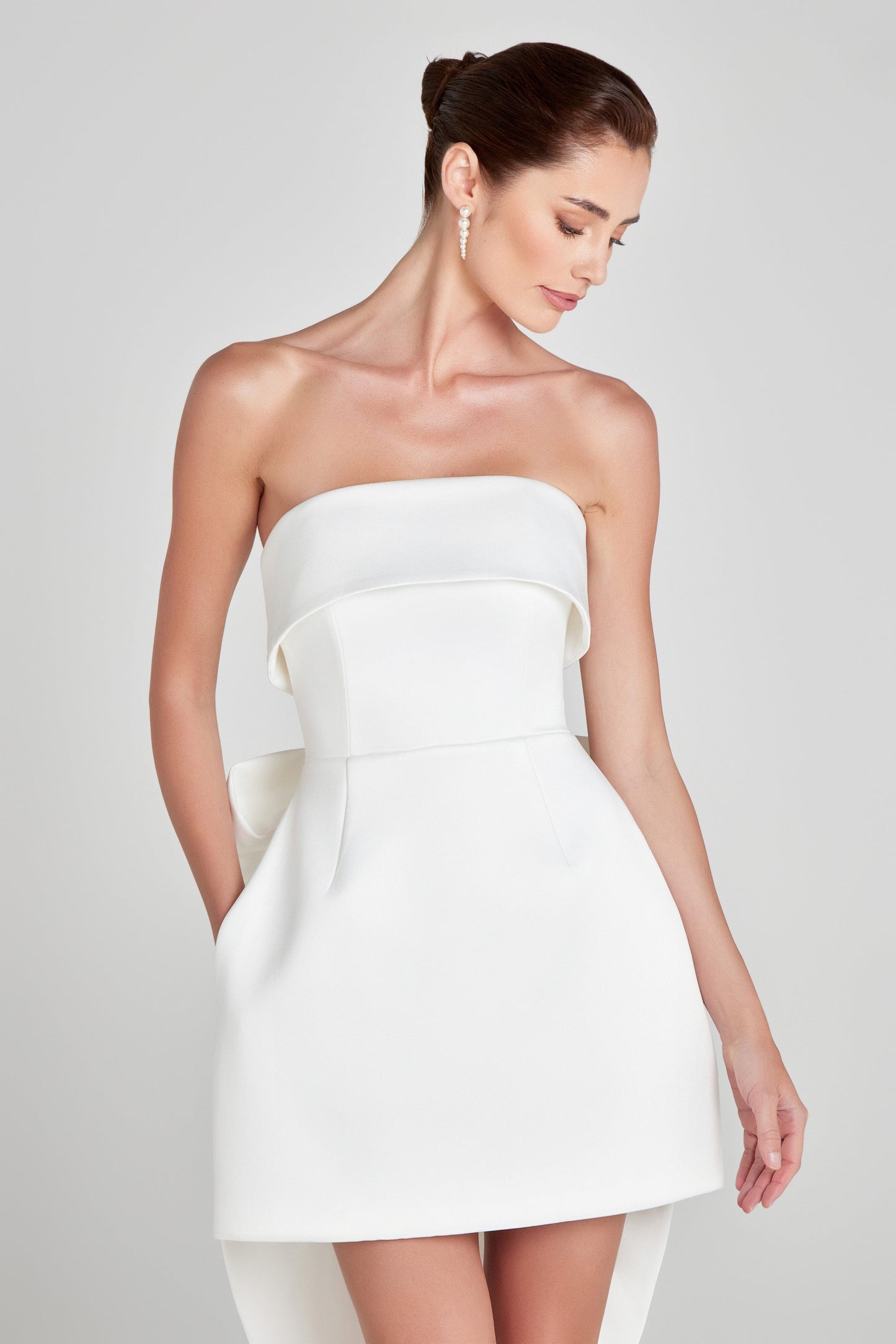 Elegant shite strapless mini dress by designer Nadine Merabi