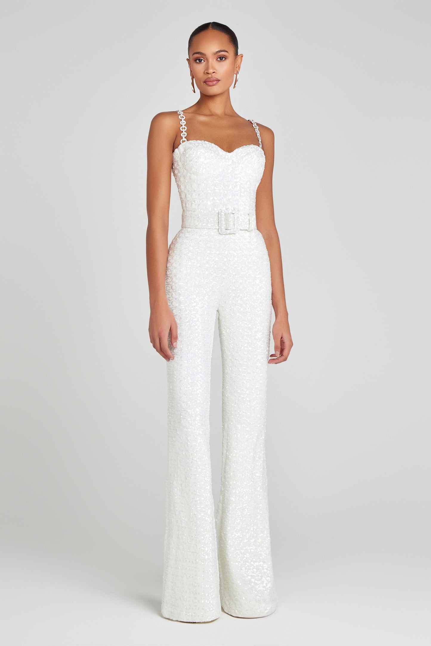 elegant white trousers and strappy white top by Nadine Merabi