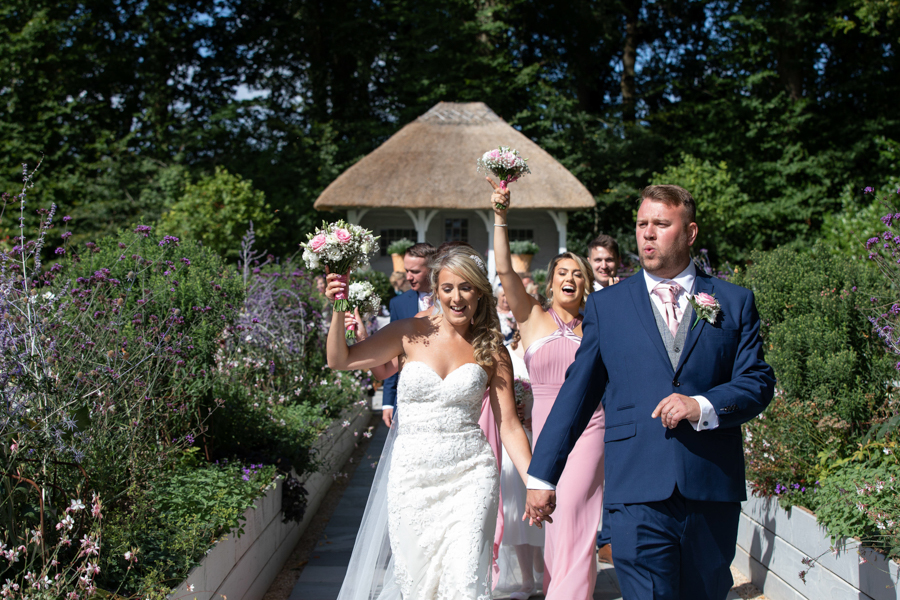 Danielle and Jason dancing down the aisle at Deer Park Hotel Devon by Evolve