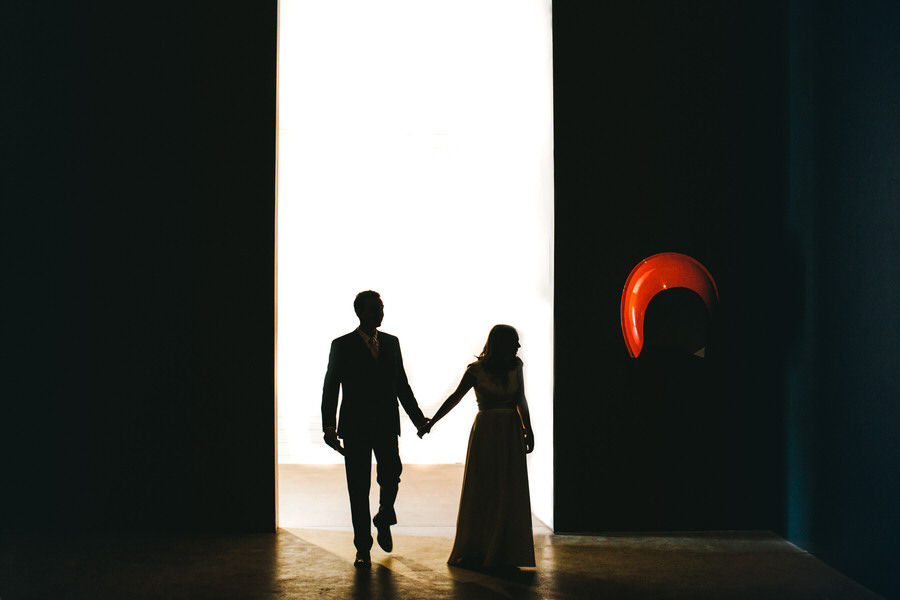 silhouette of bride and groom in a large open doorway