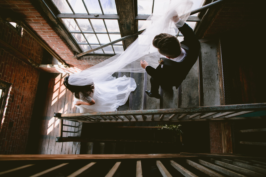 overhead photo of bride and groom descending stairway