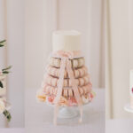 Three tiered wedding cakes, one with pastel flowers, one with macarons and one with dried flowers, by Scrumptious Bakes by Emma