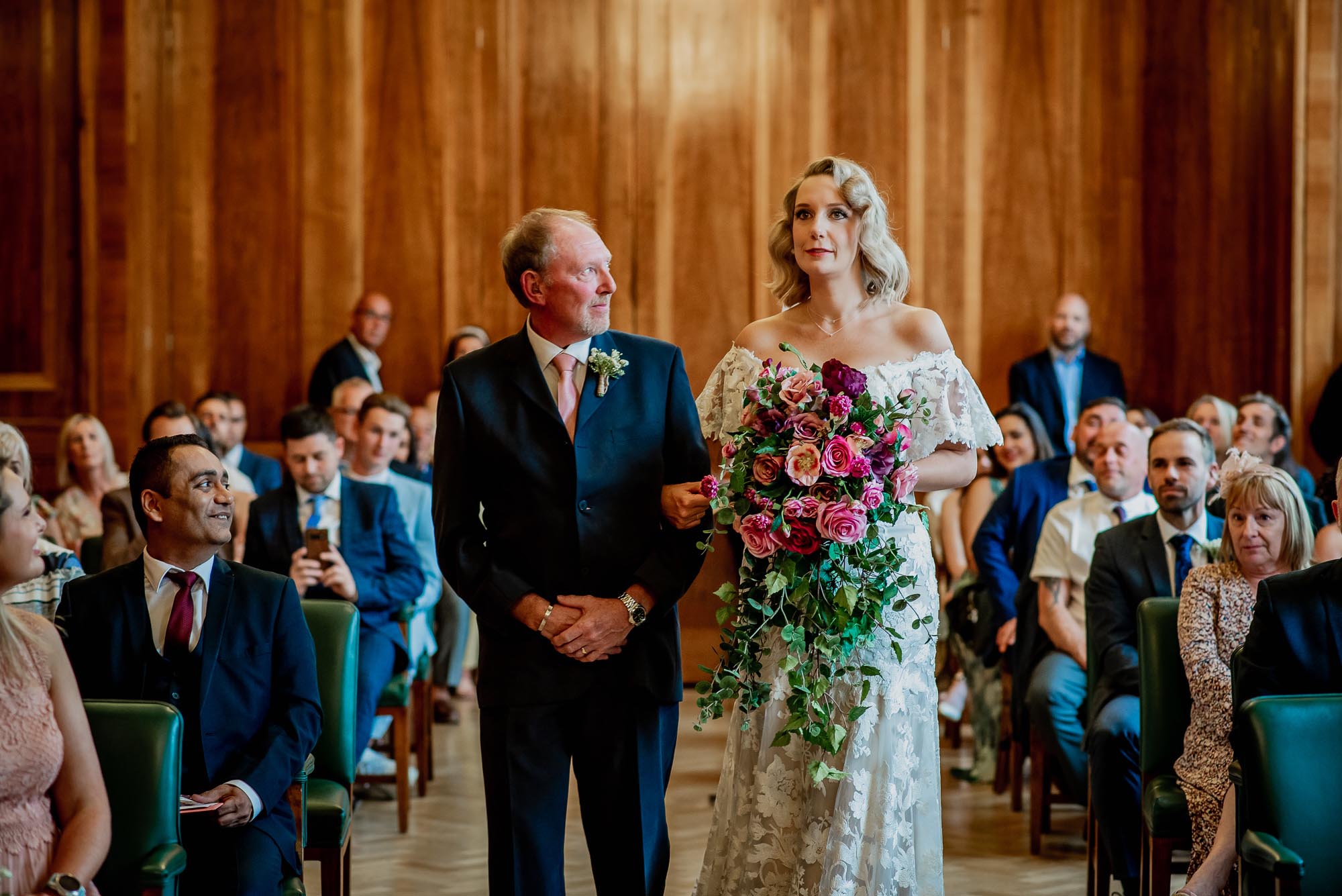 Chris and Sarah's London wedding with vibrant pink florals made by the bride. Photographer credit Damien Vickers Photography