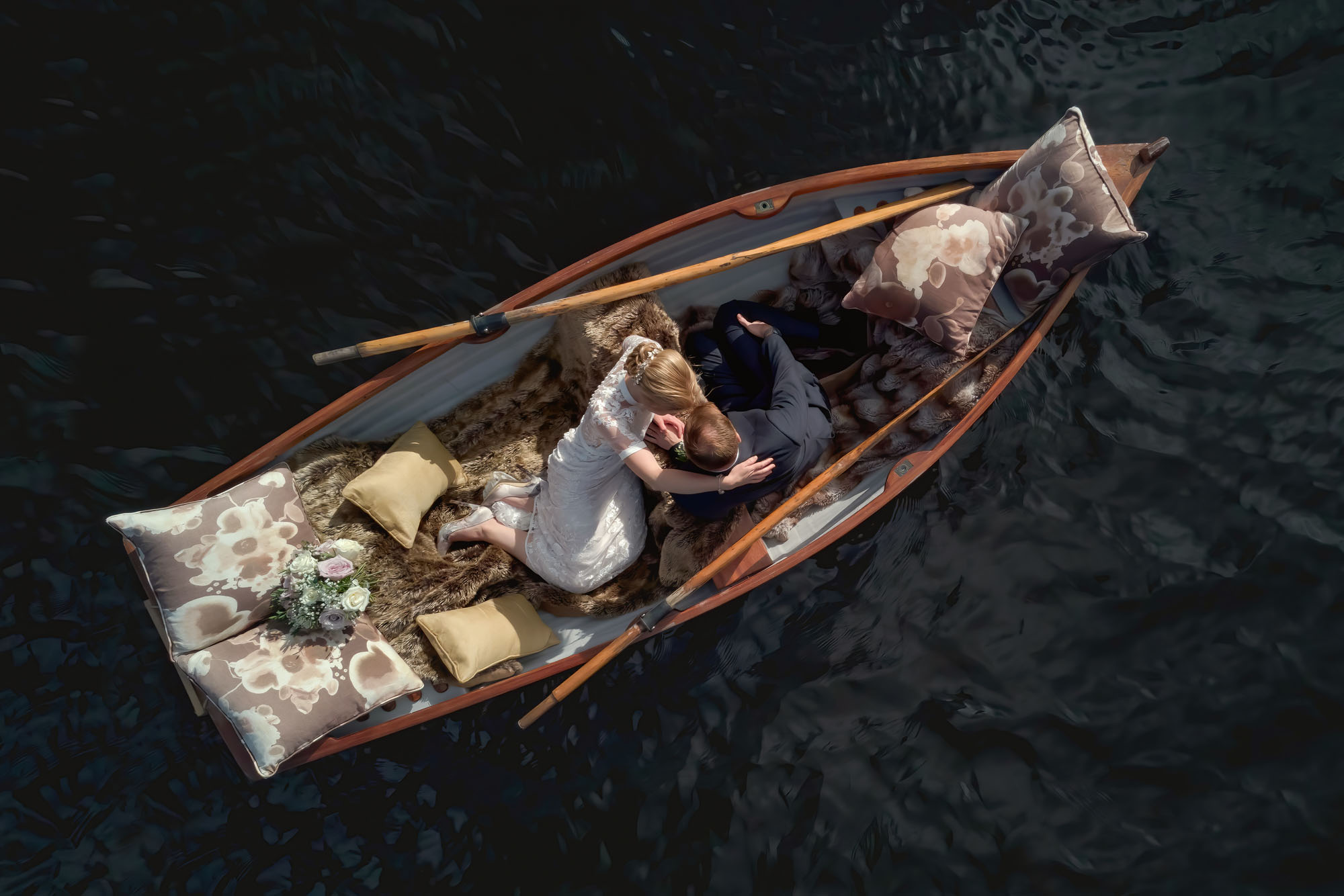Drone photo of a couple sat in a rowing boat. By Jaye-Peg Photography
