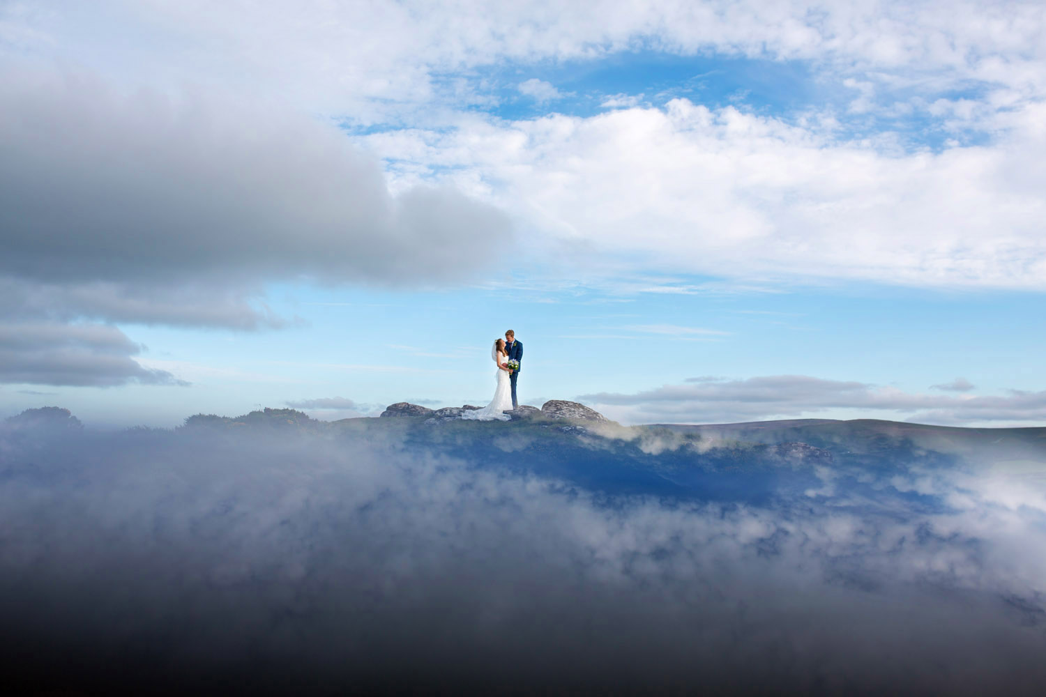 Wide angle photo of a couple on a summit in a cloud inversion. Taken by Somerset photographer Martin Dabek Photography