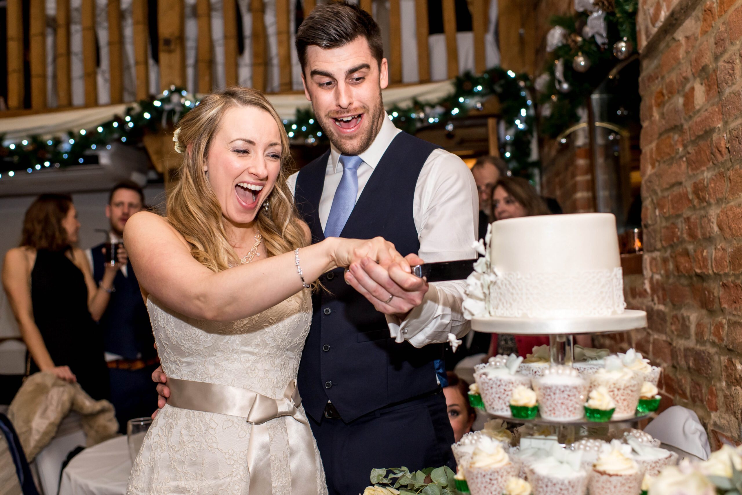 Newlyweds cutting the cake, by Tori Deslauriers Photography