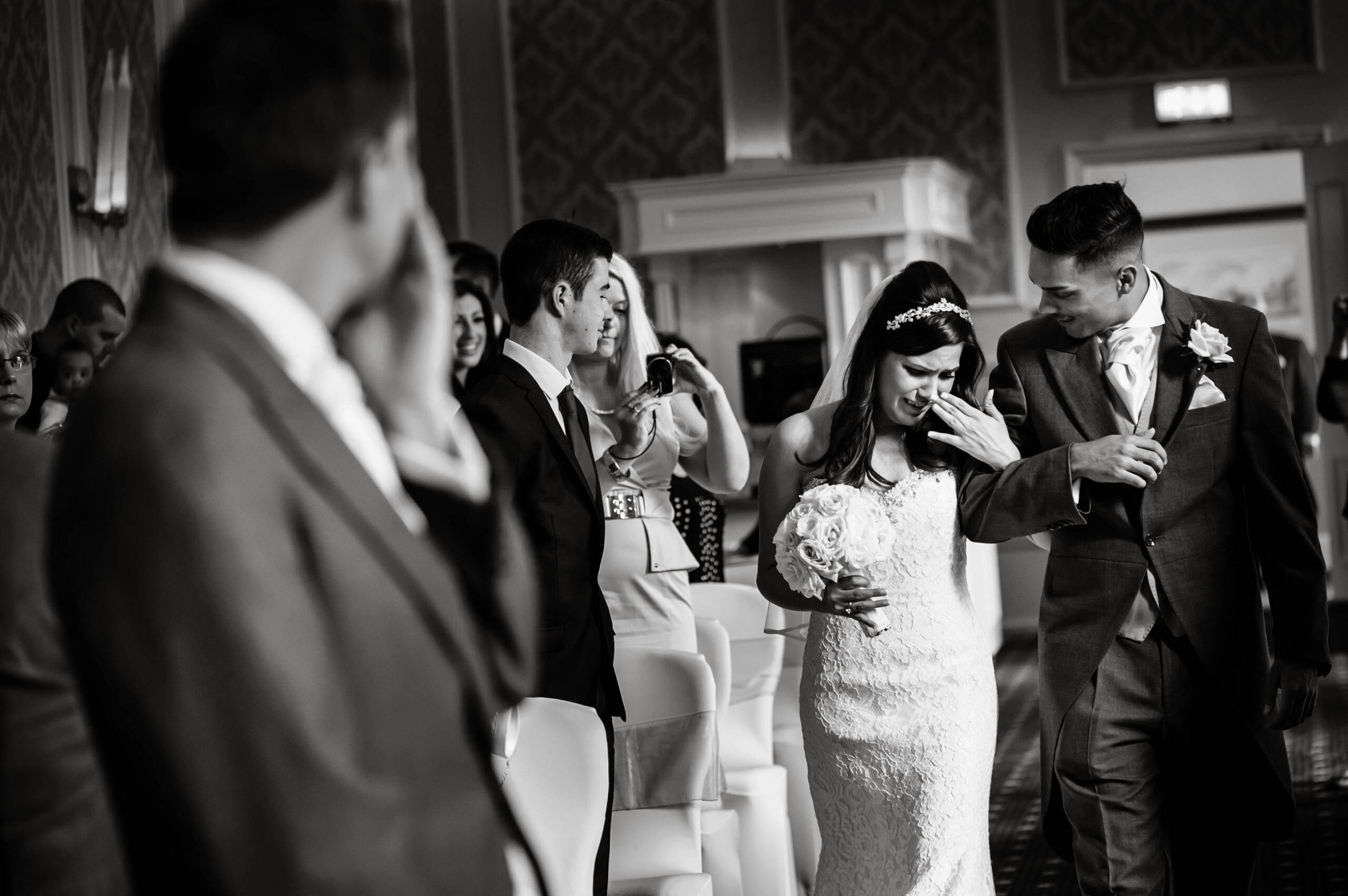 An emotional bride walking down the aisle, by Tori Deslauriers Photography