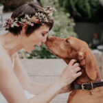 A bride with her dog, nose to nose