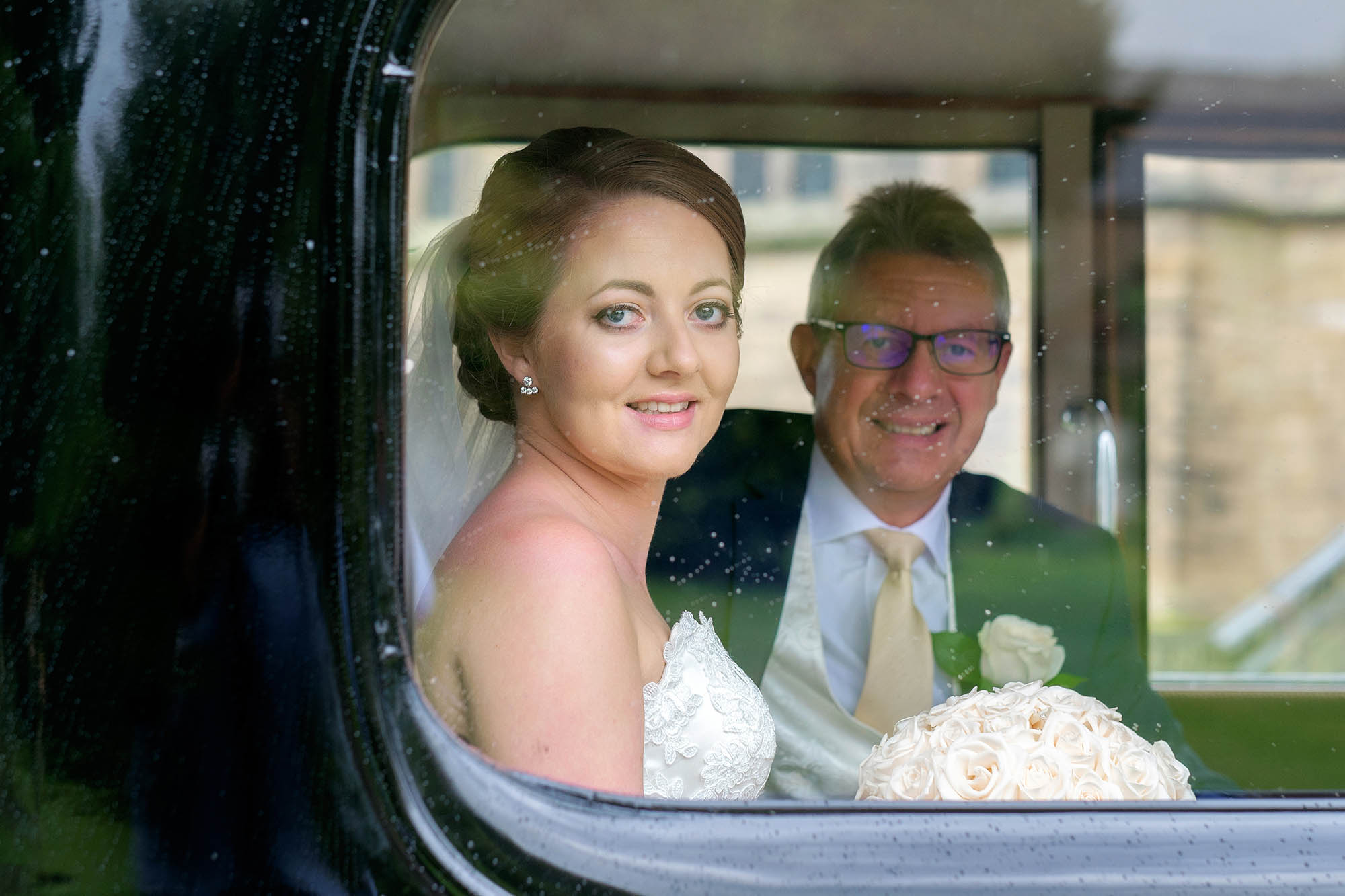A bride and her dad in their vintage wedding car - Sheffield wedding photographer John Mottershaw