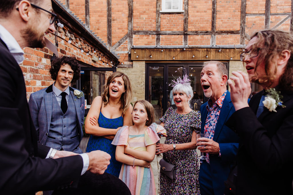 Fascination on the faces of wedding guests with Close-Up Chris aka UK wedding magician Chris Peskett