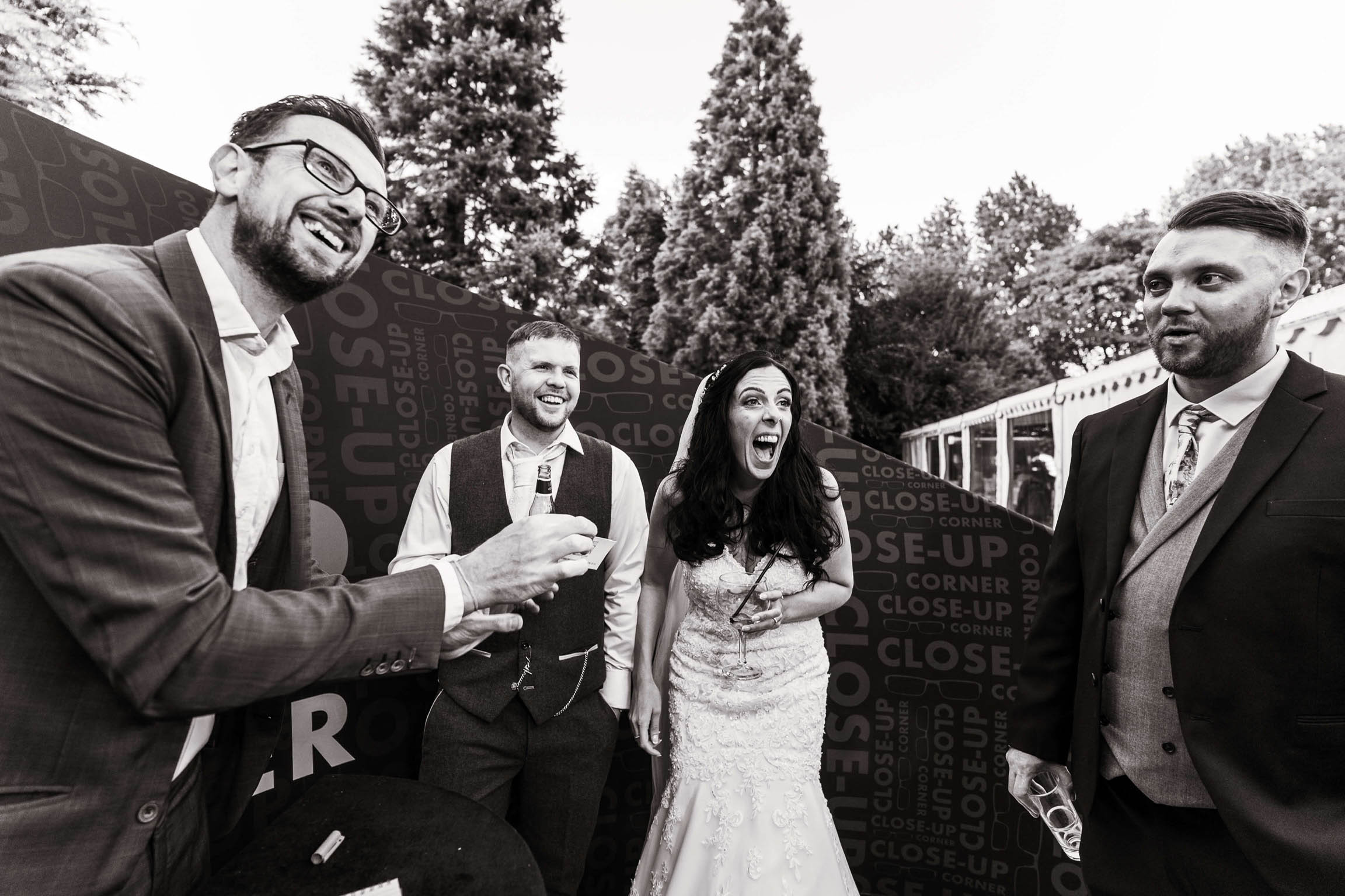Black and white photo of a bride and groom amazed at their UK wedding magician Close-Up Chris