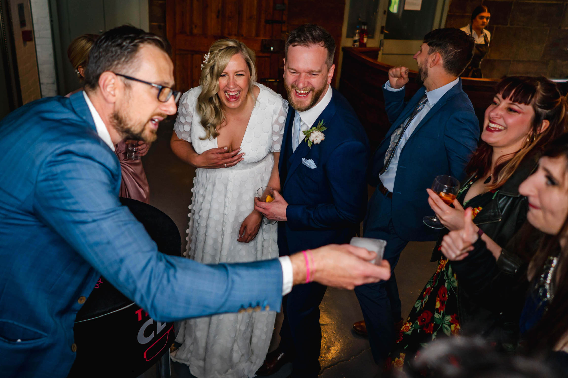 Amazement on the faces of a bride and groom with their guests watching the performance of UK wedding magician Close-Up Chris