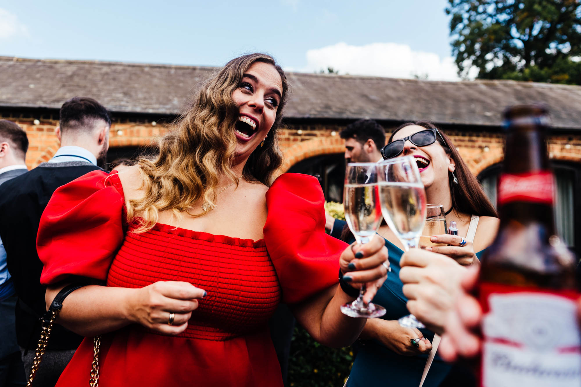 Wedding guests celebrate with some lovely fizz - by Hannah Hall Photography
