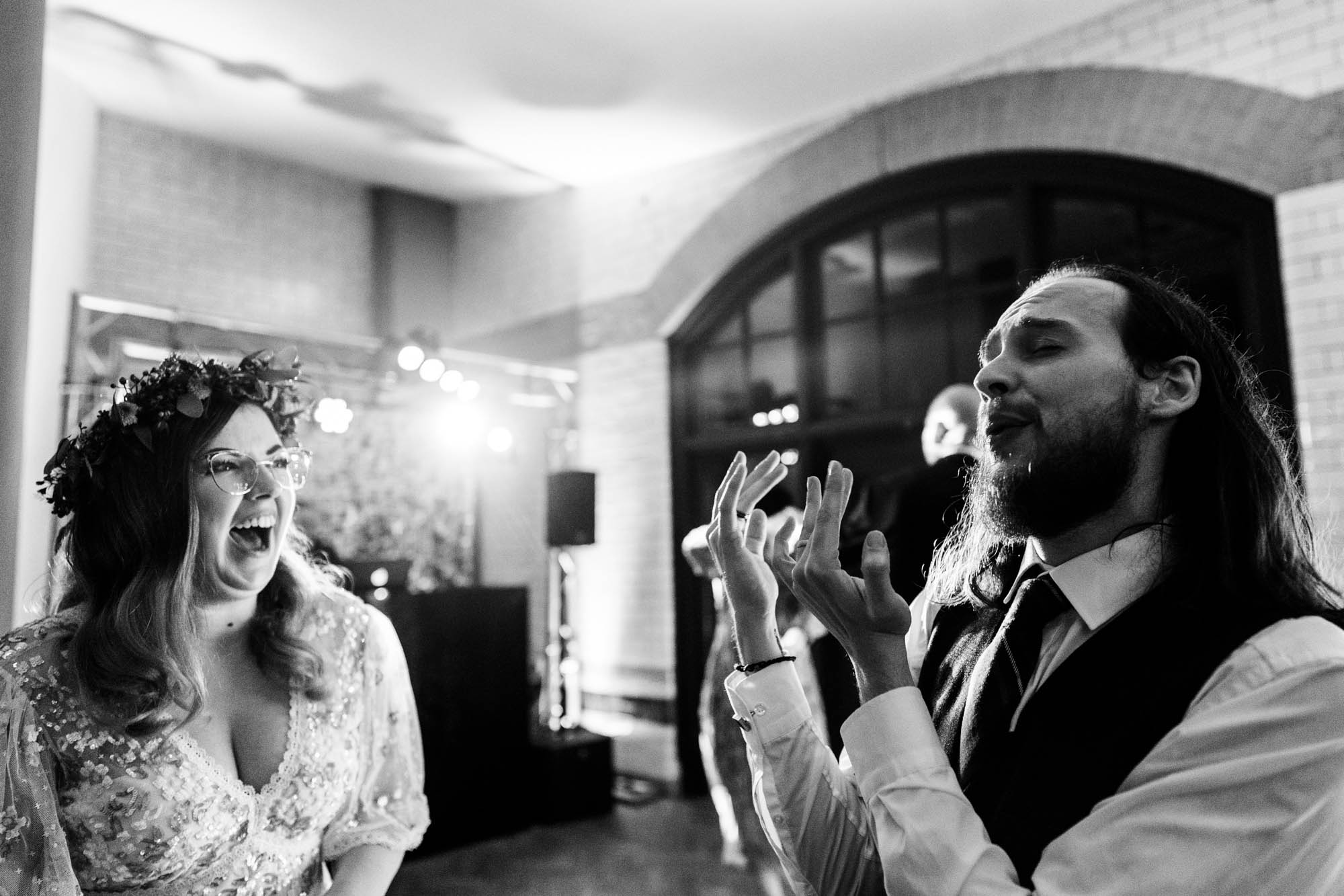 Bride and groom celebrating on the dance floor - by Hannah Hall Photography