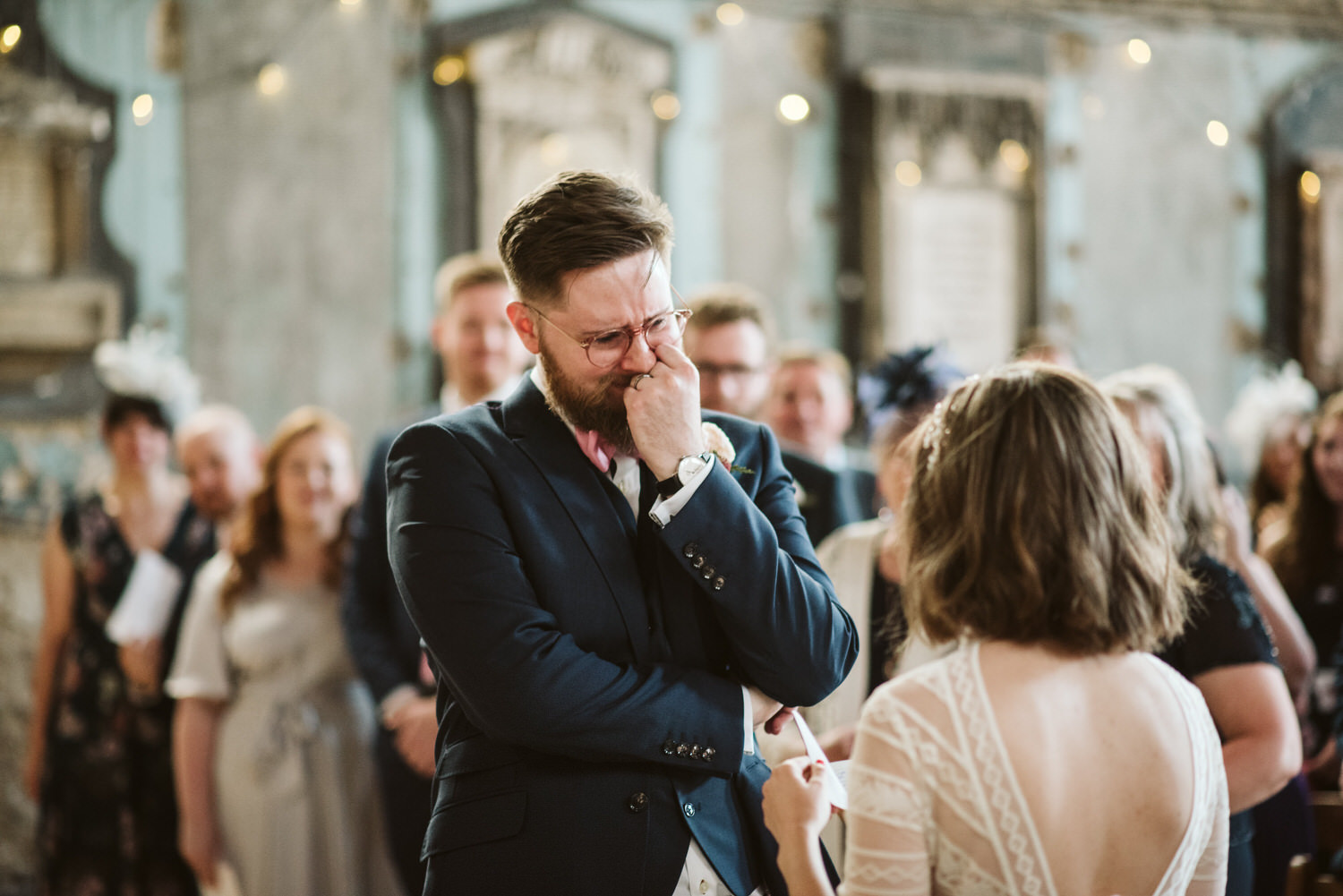 A groom holds back the happy tears at the altar. London wedding photographer Ellie Gillard
