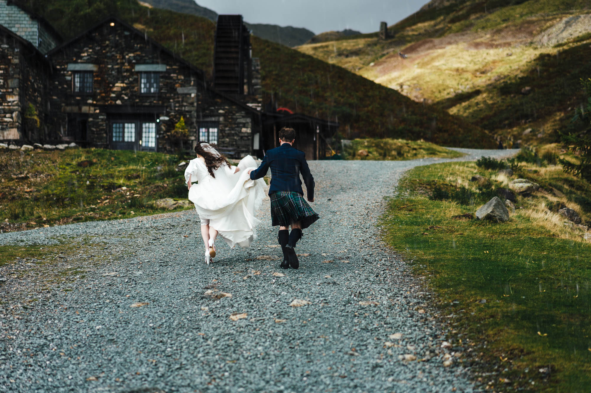 Groom and bride walking towards the Coppermines Cottages in Coniston - credit Hannah Hall Photography