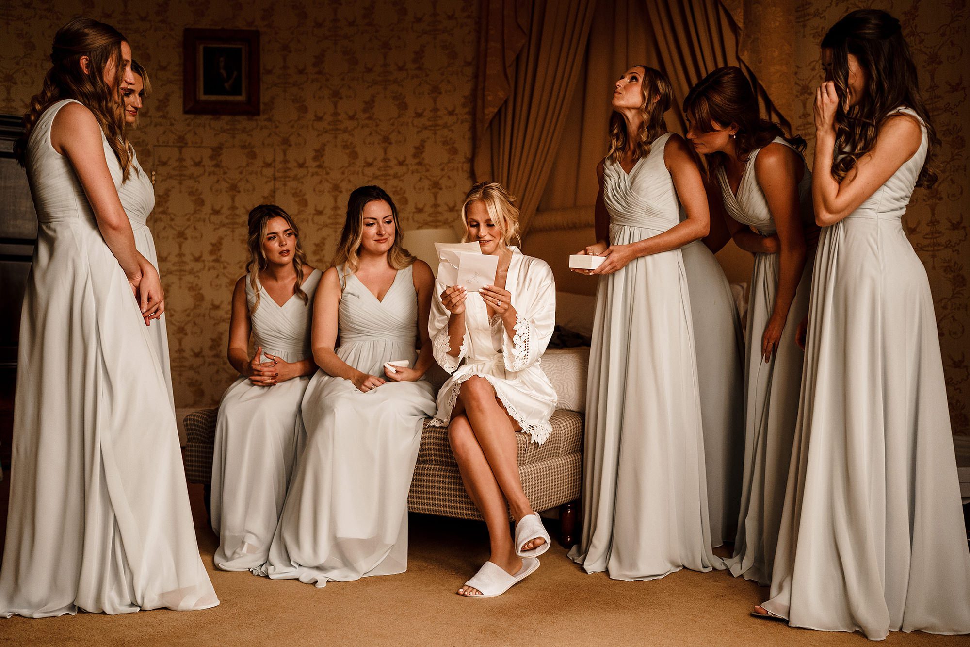 Bridesmaids watch as a bride reads a letter out loud. By Stephen Walker Photography
