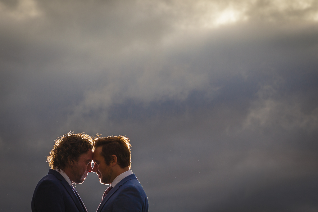 Moody and dramatic wedding photography of an LGBTQ couple resting their foreheads against one another. Beautifully captured by Ross Willsher Photography