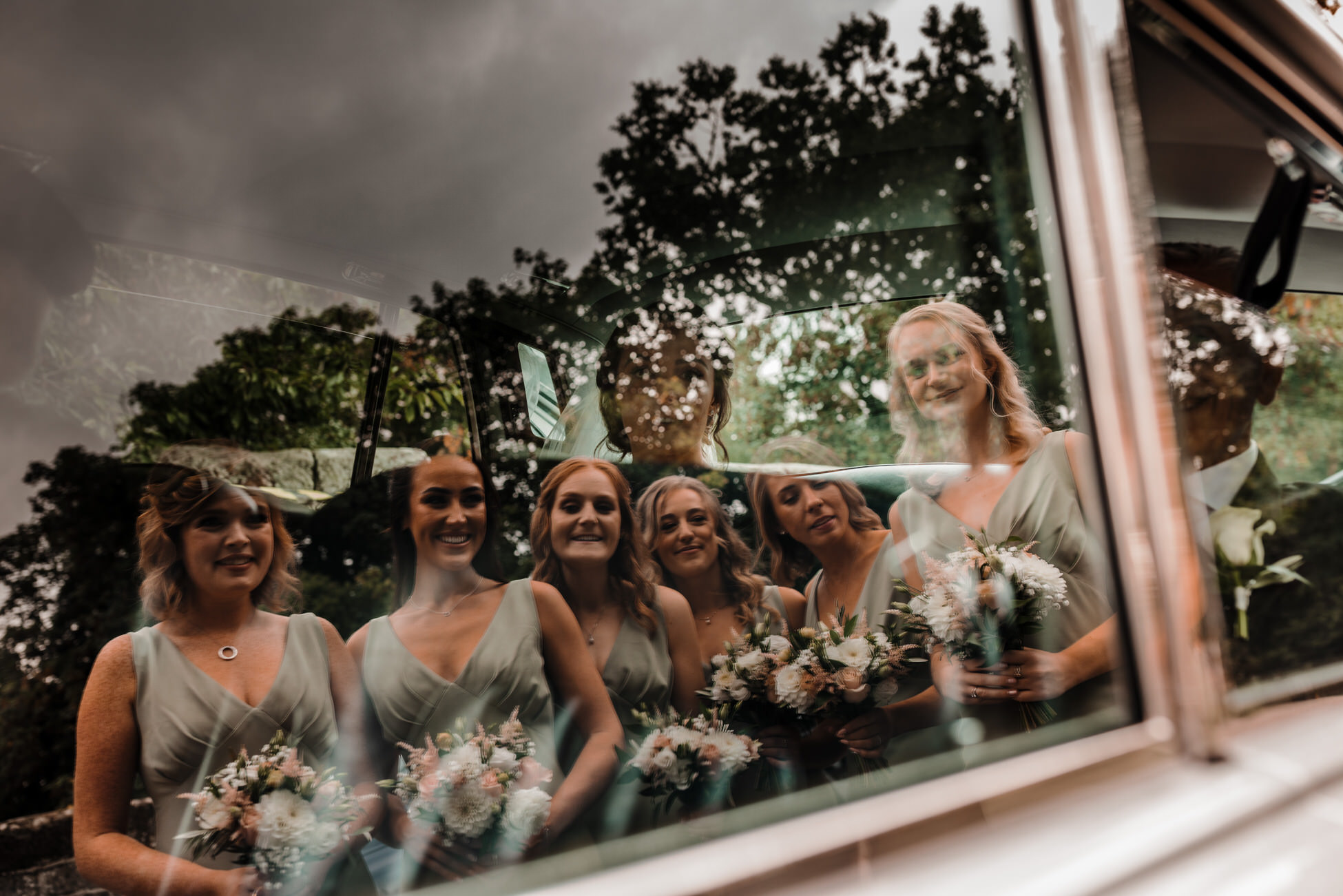 Beautiful reflective image of bridesmaids at John and Sarah's wedding. Taken by Derbyshire wedding photographer Tom Hodgson