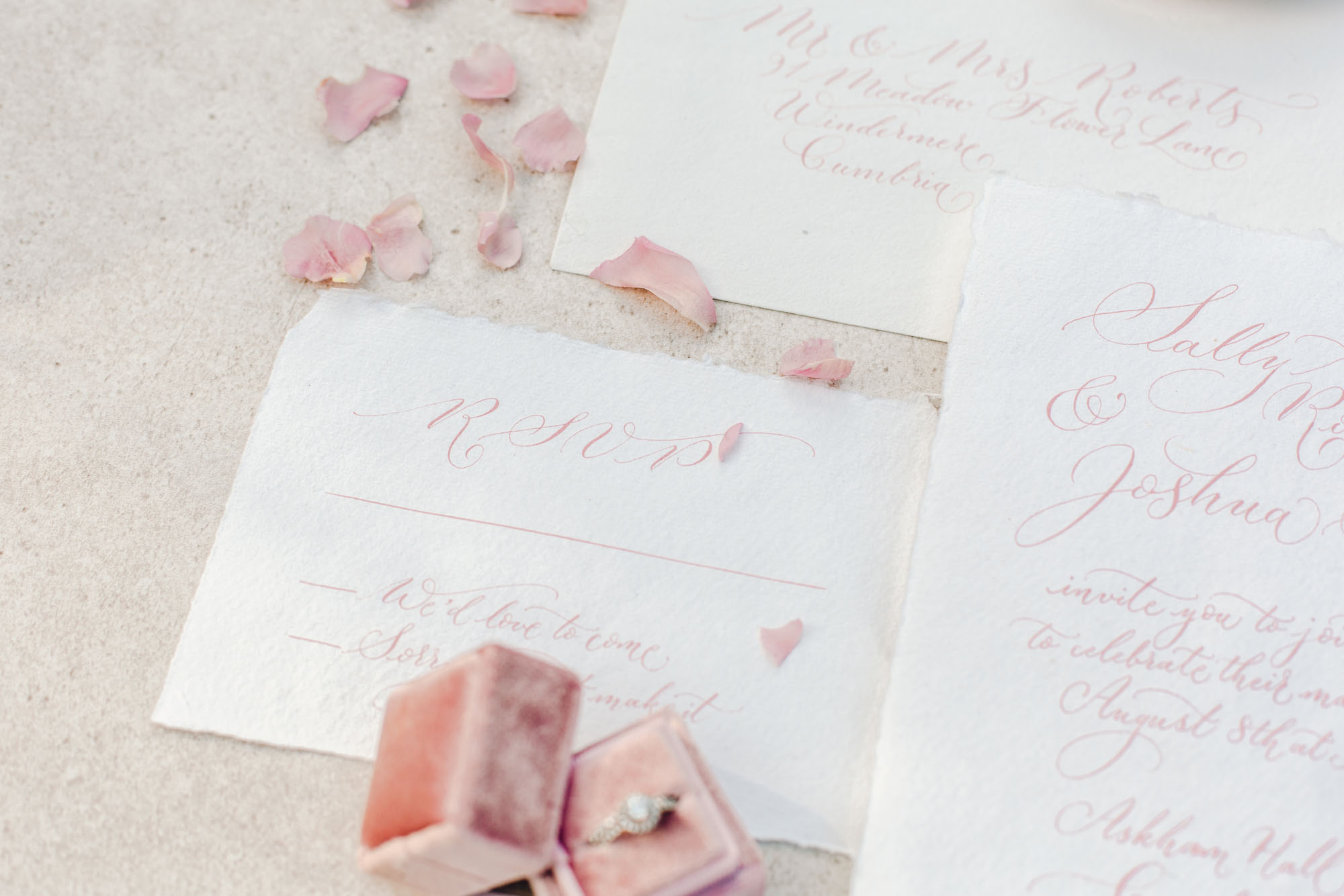Delicate blush pink wedding invitation handwritten in modern calligraphy