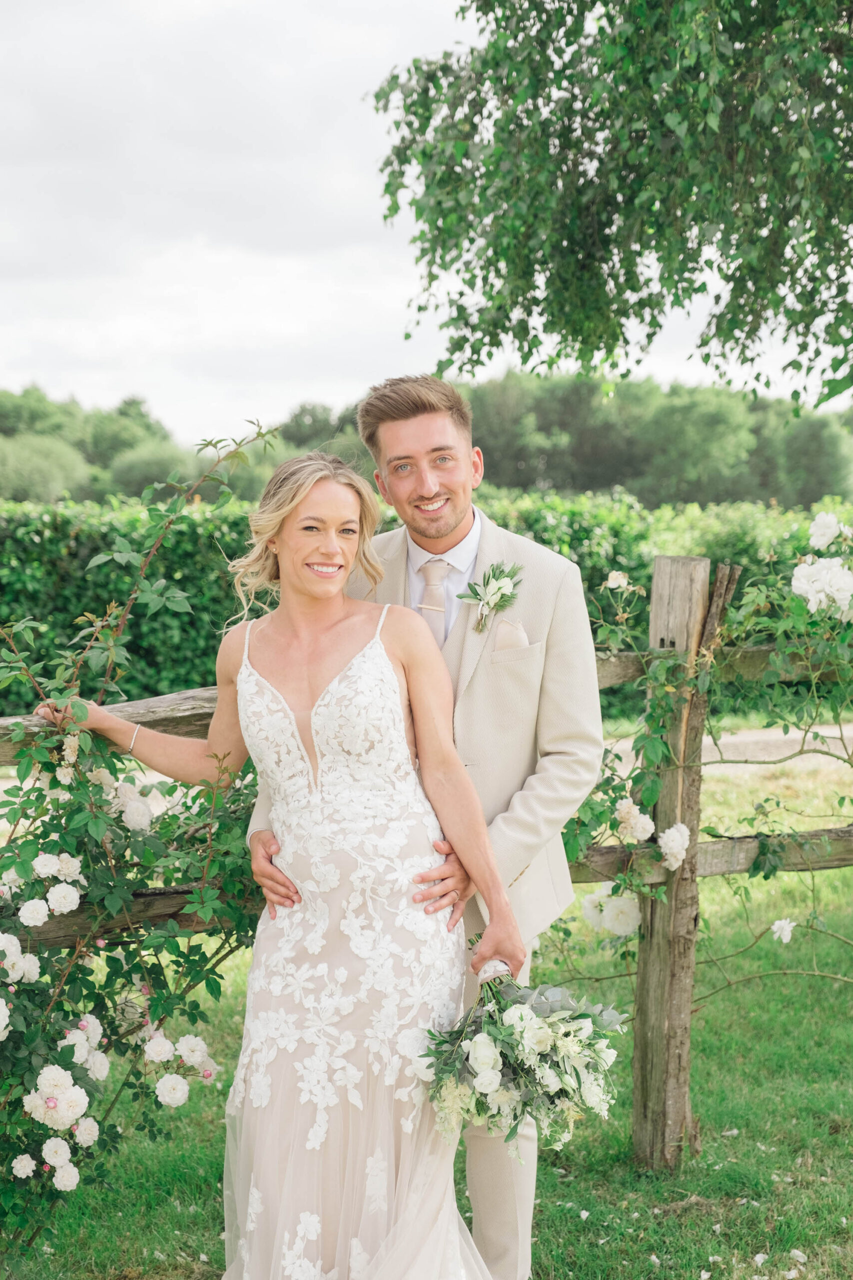 A light and airy photo of a bride and groom. She's in a strappy dress and he's in a pale suit. By Jordan Fox Photography