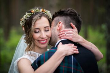 Close up romantic photo of a groom and bride hugging. by Smiling Tiger Studios