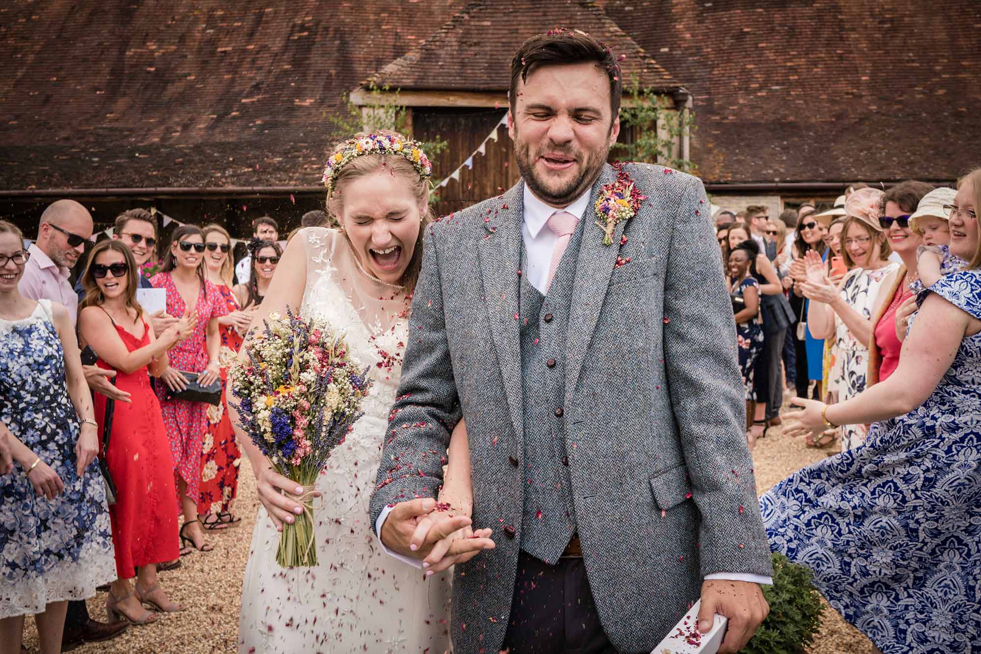 Groom and bride doing a brilliant confetti face as they walk between their guests! Smiling Tiger Studios, Dorset
