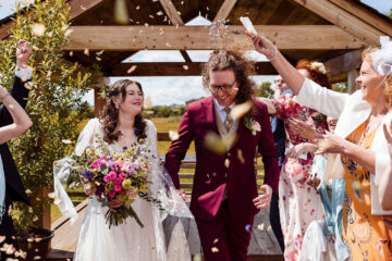 Newlywed couple having their confetti moment at Eden Barn with Cumbria wedding photographer Mark Battista