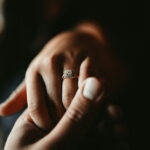 engagement ring on a hand being held by another hand