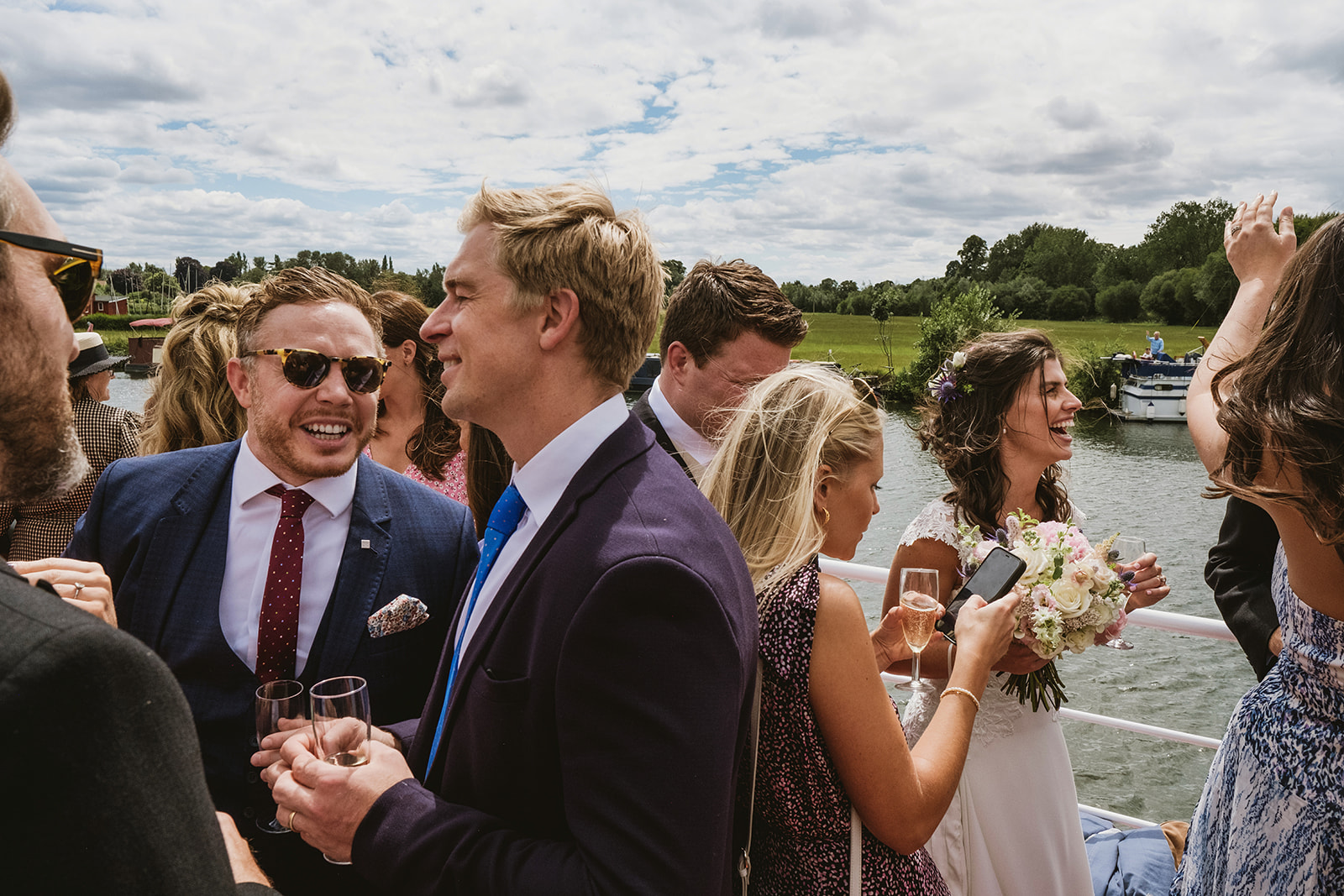 groom and bride celebrating with guests by award winning London documentary wedding photographers York Place Studios