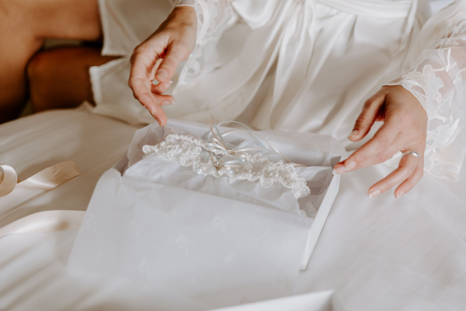 bride with a handmade wedding garter by Catherine at Silk Garters