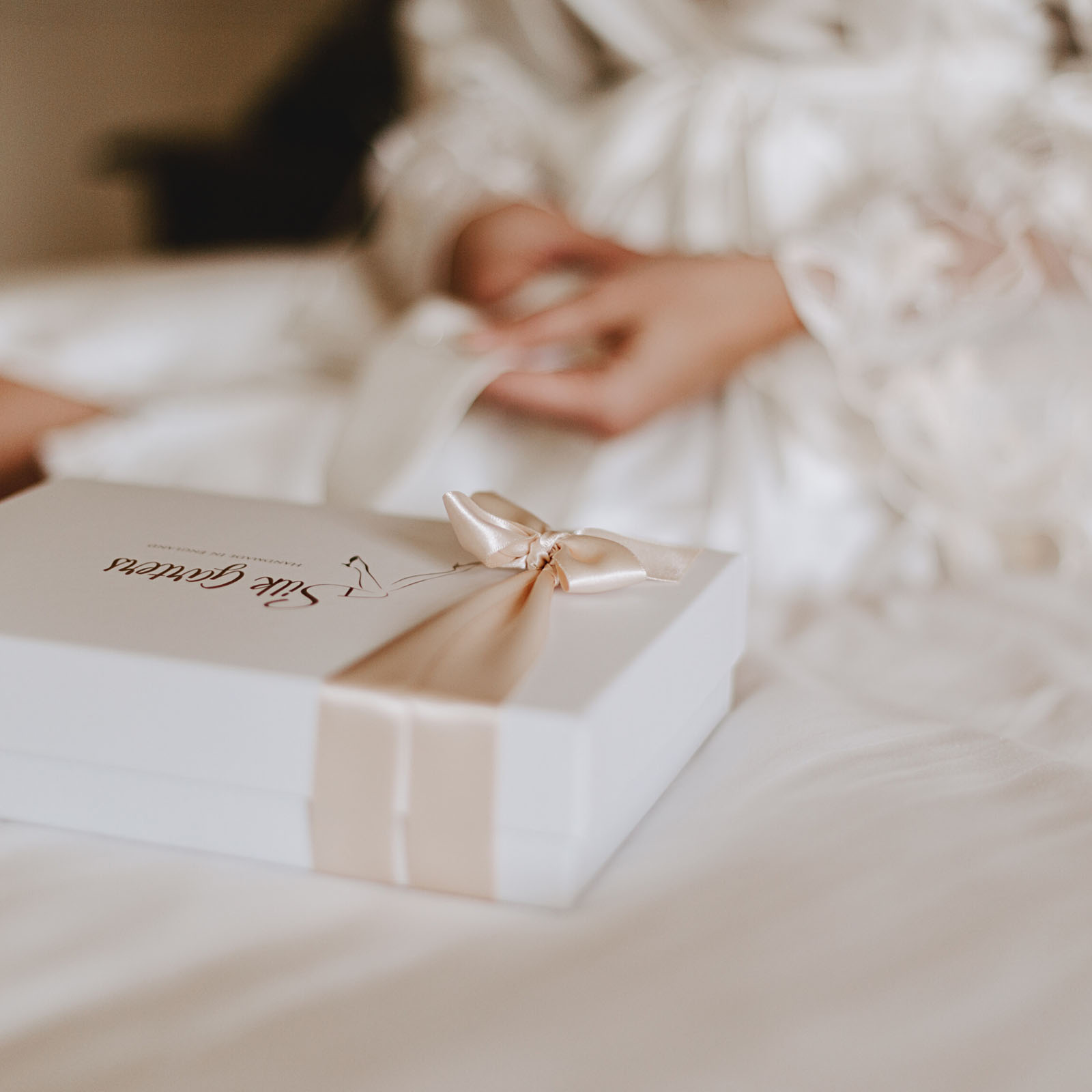 bride with a handmade wedding garter by Catherine at Silk Garters