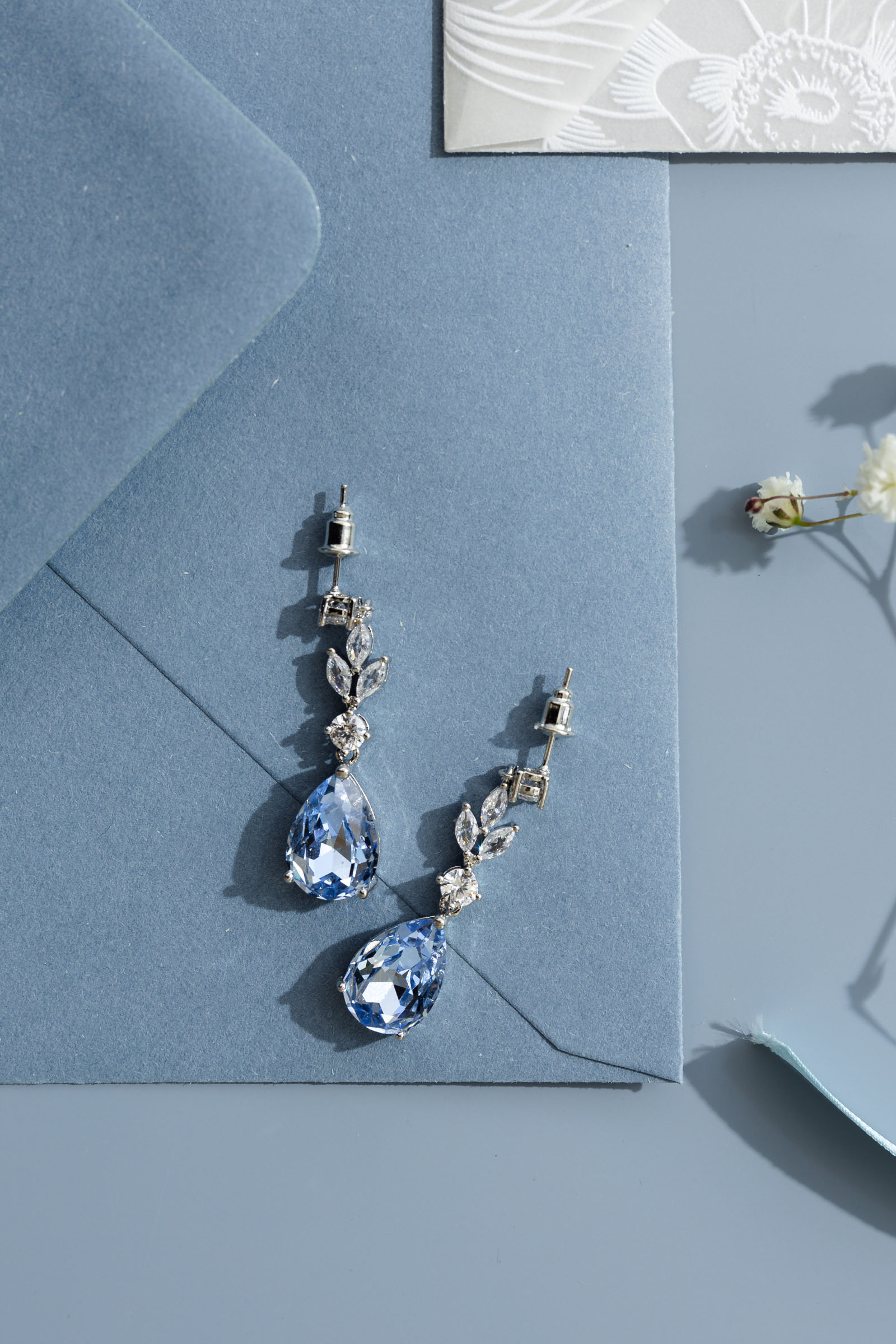 an assortment of pale, dusky and soft blue bridal jewellery and accessories made in the UK by Emma Rose Jewellery