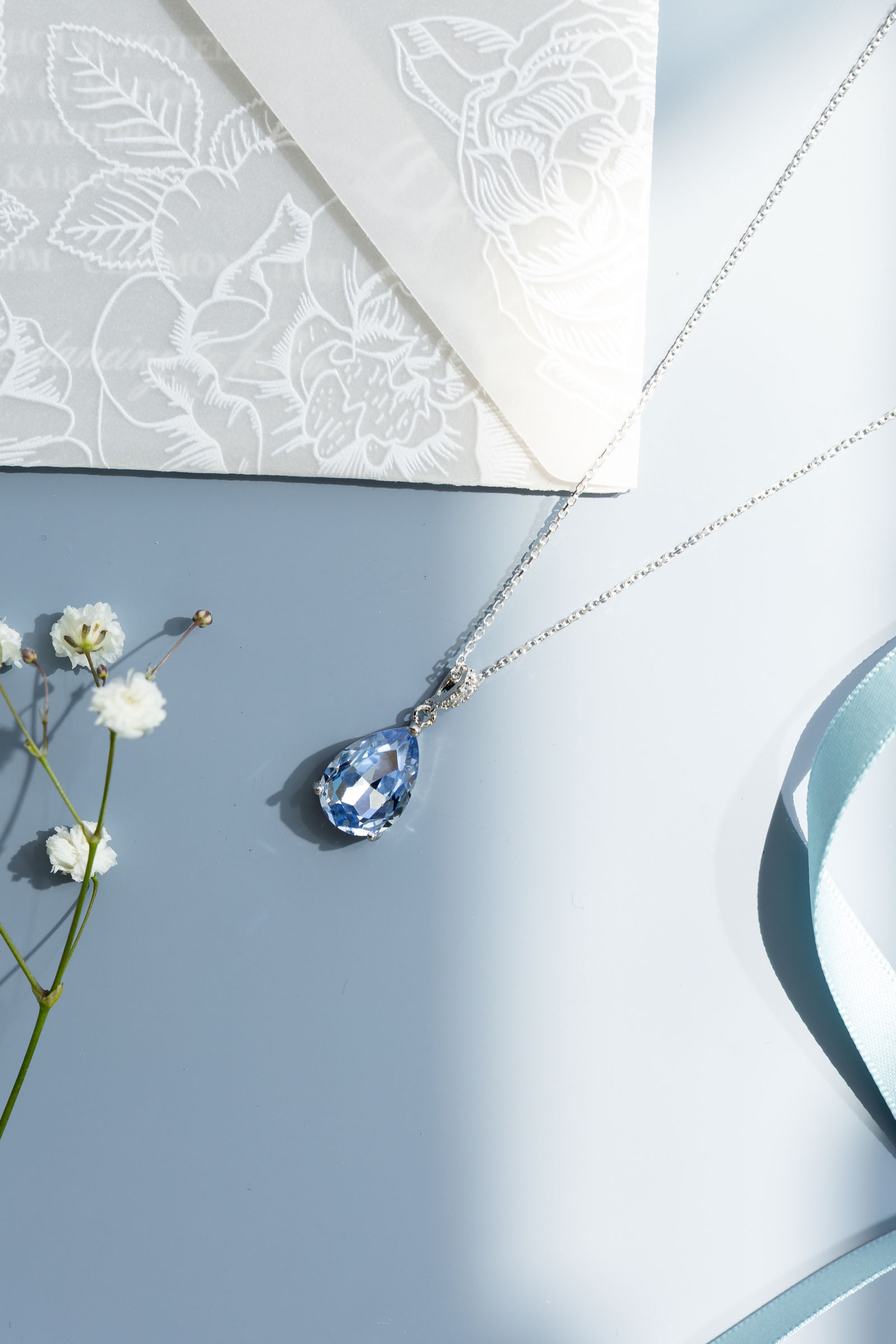an assortment of pale, dusky and soft blue bridal jewellery and accessories made in the UK by Emma Rose Jewellery