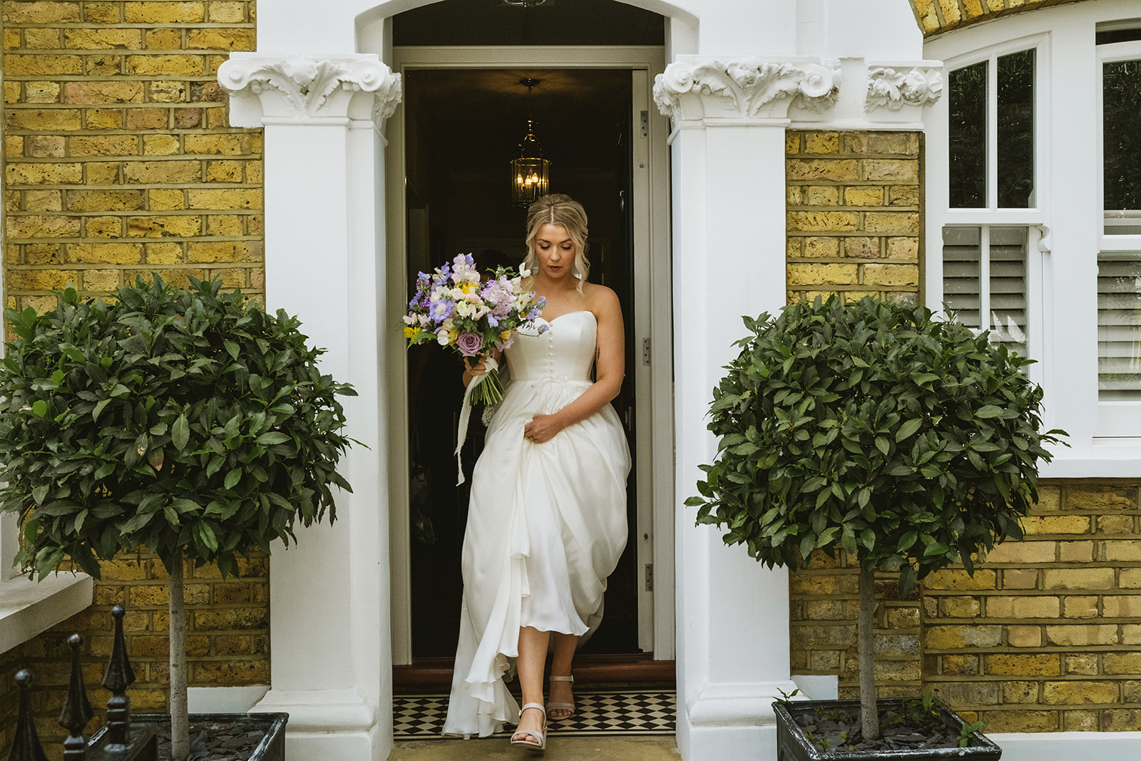 photos from a Battersea Arts Centre wedding with meadow style florals and natural street photography style with York Place Studios
