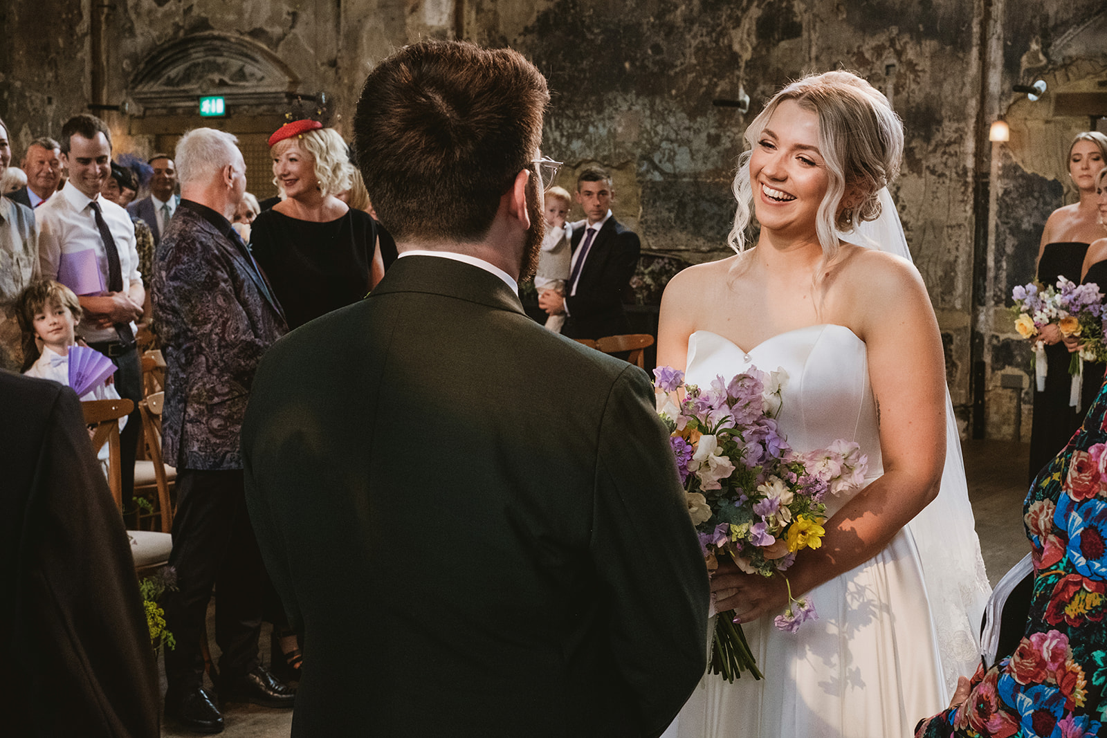 photos from a Battersea Arts Centre wedding with meadow style florals and natural street photography style with York Place Studios