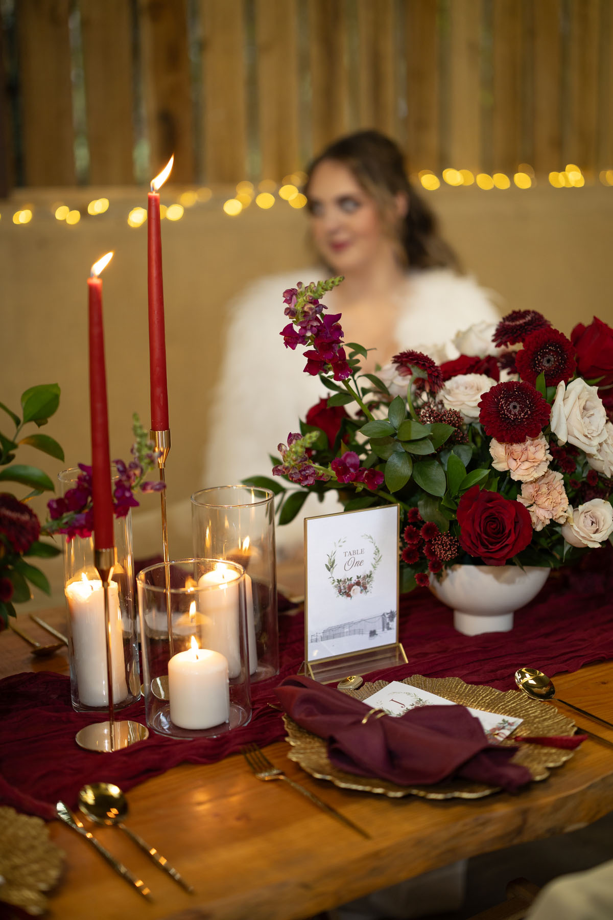 warm red winter wedding ideas with candlelight from a setup at Battleford with photographer Howard South West