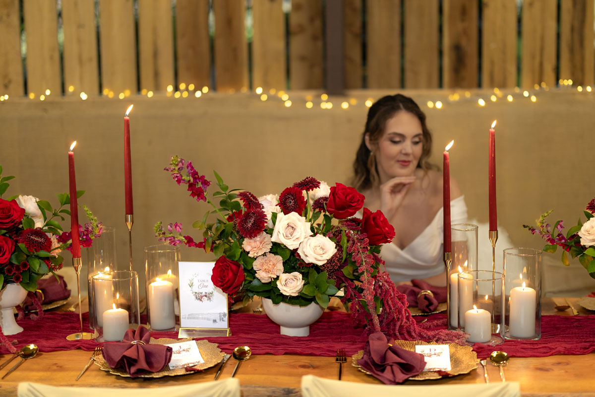 warm red winter wedding ideas with candlelight from a setup at Battleford with photographer Howard South West