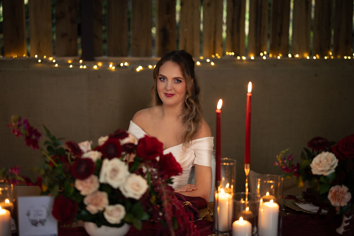 warm red winter wedding ideas with candlelight from a setup at Battleford with photographer Howard South West