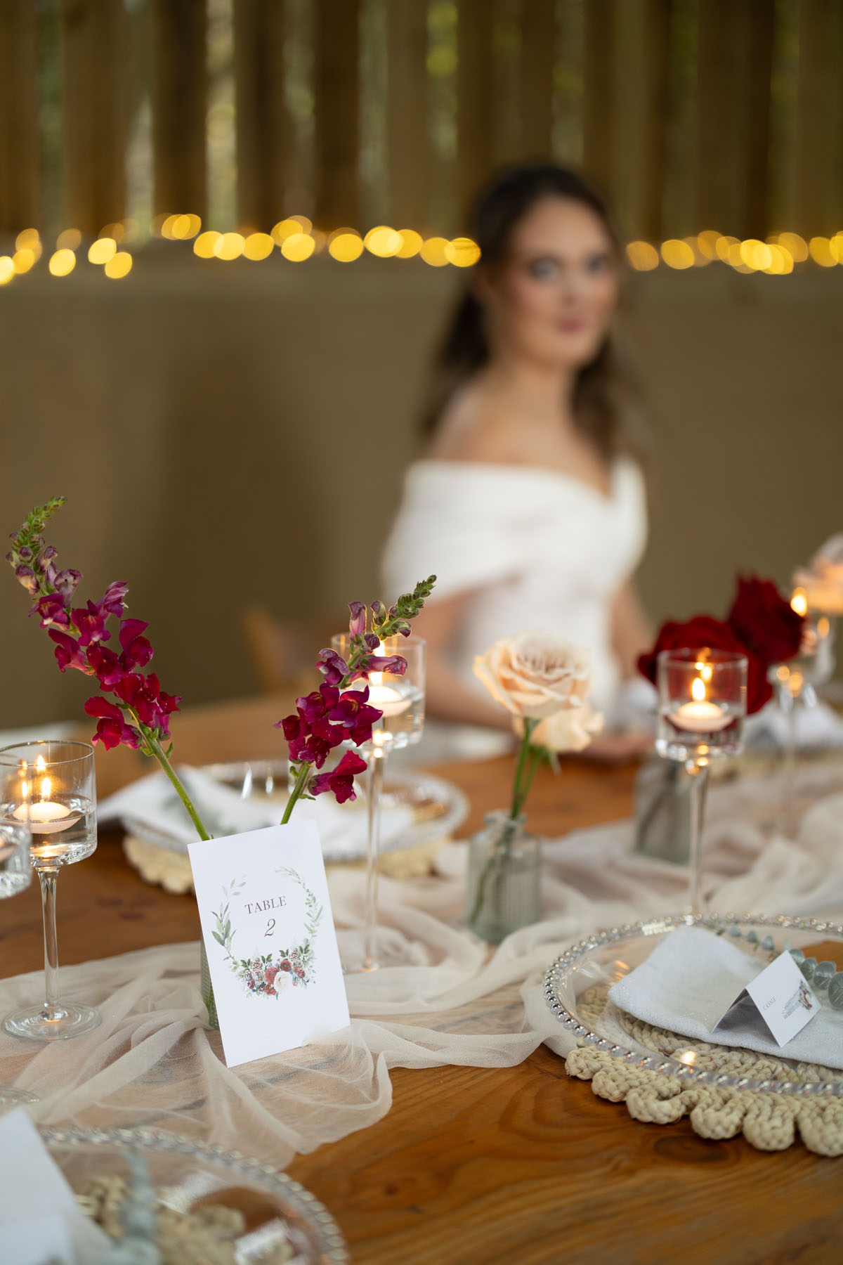 warm red winter wedding ideas with candlelight from a setup at Battleford with photographer Howard South West