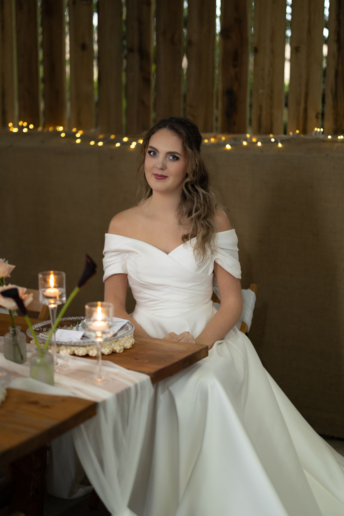 warm red winter wedding ideas with candlelight from a setup at Battleford with photographer Howard South West