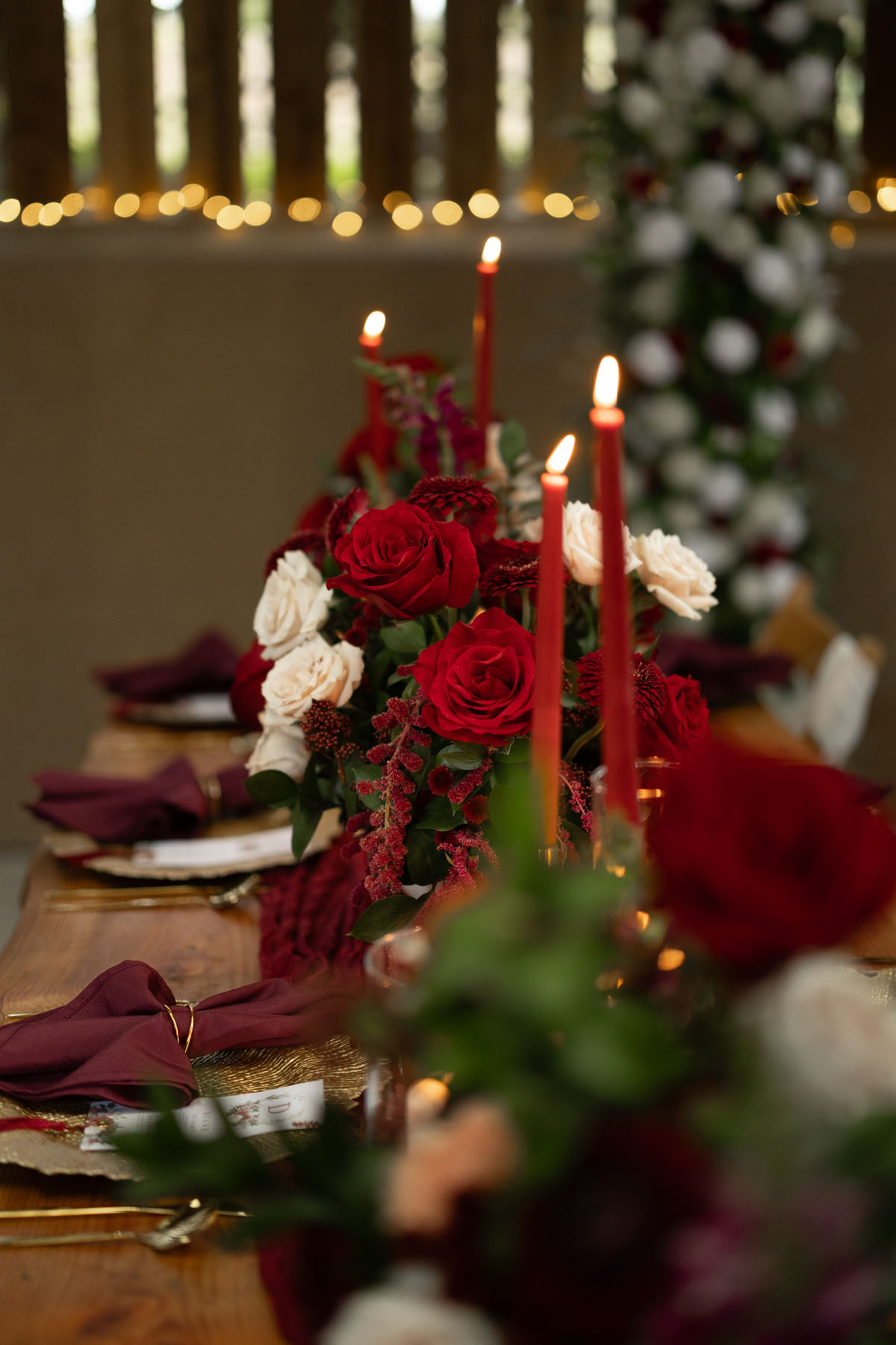 warm red winter wedding ideas with candlelight from a setup at Battleford with photographer Howard South West