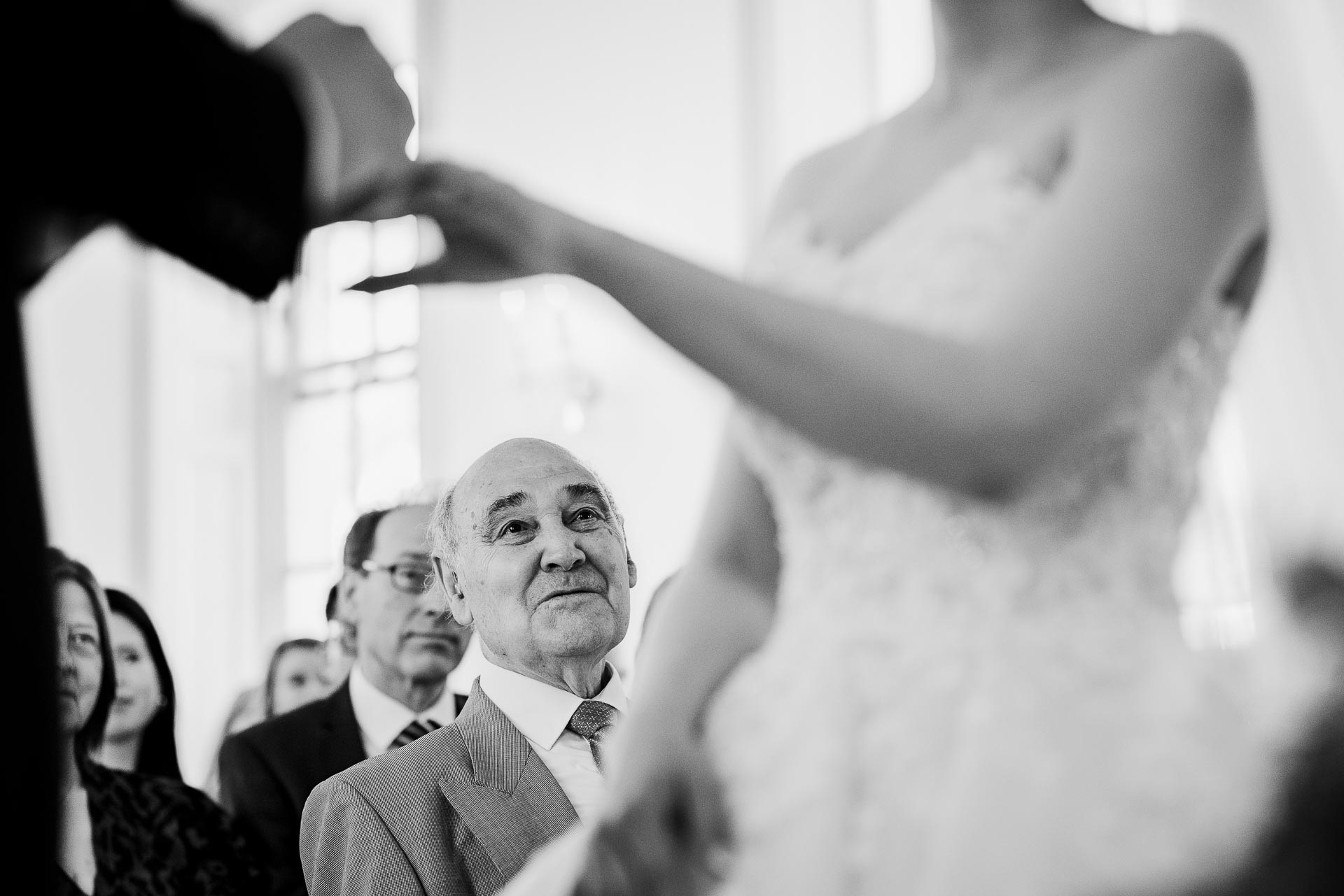 black and white wedding photography of a proud dad watching his daughter by Libra Photographic